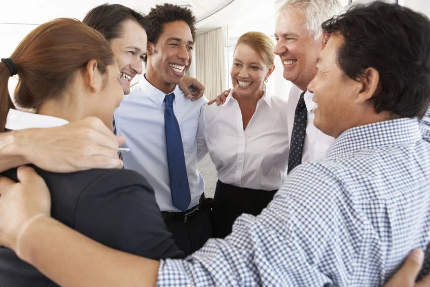 Group Of Businesspeople Bonding In Circle At Company Seminar | Appreciation at Work with Dr. Paul White